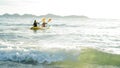 Defocused couple woman paddling a kayak on the beach. Summer adventure and kayaking with lots of splashes near the beach at sunny Royalty Free Stock Photo