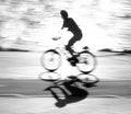 Defocused cyclist silhouette and shadow on a bike path