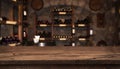 Defocused dark wine cellar background with wooden table in front Royalty Free Stock Photo