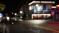 Defocused evening street. Lights of city, cars on rainy night. Road in soft focus. Twilight in USA. Royalty Free Stock Photo