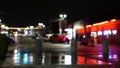 Defocused evening street. Lights of city, cars on rainy night. Road in soft focus. Twilight in USA. Royalty Free Stock Photo