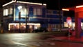 Defocused evening street. Lights of city, cars on rainy night. Road in soft focus. Twilight in USA. Royalty Free Stock Photo