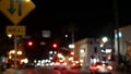 Defocused evening street. Lights of city, cars on rainy night. Road in soft focus. Twilight in USA. Royalty Free Stock Photo