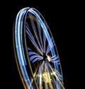 Defocused Ferris Wheel at amusement park at night. Blur abstract spinning wheel background Royalty Free Stock Photo