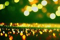 Defocused golden bokeh lights on a green background. Sparkling bright pattern. Holiday wallpaper Royalty Free Stock Photo