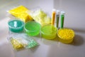 Defocused green yellow slimes inside plastic boxes. Set of kids gunk toy, close up view. make fluffy slime at home