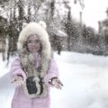 Girl out of focus and snow. Defocused happy winter funny woman