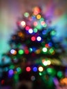 defocused image of christmas tree with colorful lights on it Royalty Free Stock Photo