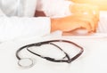 Defocused image of a doctor working with laptop computer in medical workspace office as concept with stethoscope Royalty Free Stock Photo