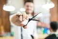 Hairdresser Holding Hair Cutting Shears While Working In Shop Royalty Free Stock Photo