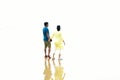 Defocused image of an Indian couple holding hands walking romantic on beach on vacation travel holidays leaving footprints in the Royalty Free Stock Photo