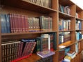 Defocused image. Multi-colored books on the bookshelf in the library. The bokeh effect Royalty Free Stock Photo