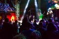 Defocused image of people crowd at concert and stage lights Royalty Free Stock Photo