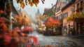 In this defocused image a quaint town square is drenched in the warm glow of autumn colors a striking blend of deep red