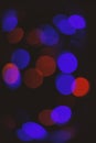 Defocused light of colorful garland. Abstract colorful bokeh background. Festive backdrop with colorful lights. Bright Royalty Free Stock Photo
