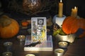 Defocused mystic ritual with tarot cards, and candles. Halloween concept