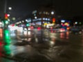 defocused night rain city street cross roads view