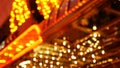 Defocused old fasioned electric lamps glowing at night. Abstract close up of blurred retro casino decoration shimmering, Las Vegas