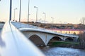 Defocused perspective view, bokeh, of a bridge at sunset with people walking at dusk