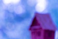 Defocused photo with a silhouette of a house on a blue bubble background. Space for lettering and design