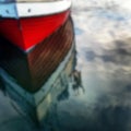 Defocused Red Boat Reflecting In Water