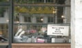 Defocused restaurant with notice on windows, We`re Open with Social Distancing