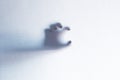 Defocused scary ghost hands behind a white glass background