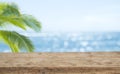 Defocused sea background with wooden table foreground for product display