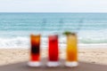 Defocused Set of Fruit Cocktails on Table on Beach with Endless Sea Horizon Royalty Free Stock Photo