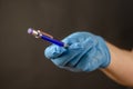 Defocused shot of doctor's hand in blue medical glove with penci Royalty Free Stock Photo