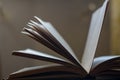 A defocused shot of an old open book. Dusty pages of a hardcover