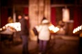 Defocused silhouettes of people in front of lighten candles in Notre-Dame de