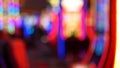 Defocused slot machines glow in casino on fabulous Las Vegas Strip, USA. Blurred gambling jackpot slots in hotel near Fremont