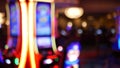 Defocused slot machines glow in casino on fabulous Las Vegas Strip, USA. Blurred gambling jackpot slots in hotel near