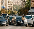 Defocused view of cars motorcycles mopeds waiting at red light with