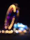 Defocused view of an illuminated Ferris wheel at night in park Wurstelprater near Wiener Prater in city Vienna, Austria. Royalty Free Stock Photo