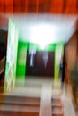 Defocused view of illuminated night entrance. A glitch in the eyes of a drunk or a drug addict