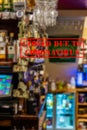 Defocused view of interior of traditional bar or pub, empty and closed due to coronavirus