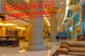 Defocused view of interior of an upmarket hotel reception, empty and closed due to coronavirus Royalty Free Stock Photo