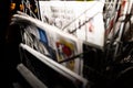 Defocused view of newspapers at night on the press kiosk