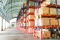 Defocused warehouse racks with cartons boxes as background