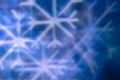White snowflake bokeh on blue background â winter holiday abstract background, front view Royalty Free Stock Photo