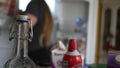 A defocused woman dances happily while cleaning out her cluttered fridge