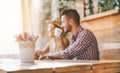 Defocused young couple drinking coffee in trendy cafe bar - Happy lovers tourists having breakfast in holiday vacation - Travel, Royalty Free Stock Photo