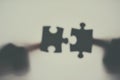 Could this be that perfect fit. Defocussed shot of two unrecognizable businesspeople holding two puzzle pieces together. Royalty Free Stock Photo