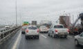 Defocussed traffic viewed through a car windscreen covered