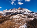 Deforestation in Alps mountains, Italy. Felled tree trunks on background of Dolomites. Aerial view