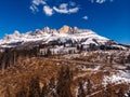 Deforestation in Alps mountains, Italy. Felled tree trunks on background of Dolomites. Aerial view