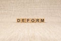 Wooden blocks with the text: deform, concept