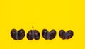 Deformed Fused fruits, ugly prunes in one row. Double fruits heart shaped on yellow background. Concept - Using in cooking